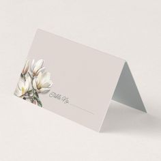 a close up of a business card with flowers on it