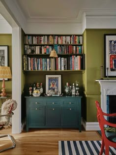 a living room filled with furniture and bookshelves covered in lots of bookcases