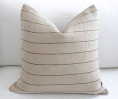 a striped pillow on a white couch