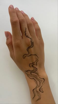 a woman's hand with a tattoo on it