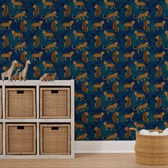 the wallpaper is green and has brown animals on it, as well as wicker baskets