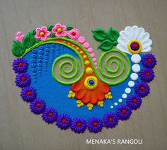 a colorful piece of art made out of felt with flowers and swirls on it