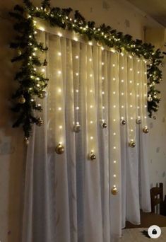 the curtain is decorated with lights and greenery