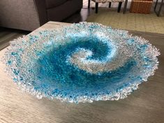 a glass bowl sitting on top of a wooden table