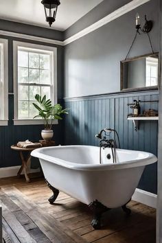 a white bath tub sitting inside of a bathroom next to a wooden floor and window