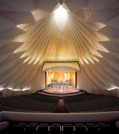 an auditorium with rows of seats and lights on the ceiling