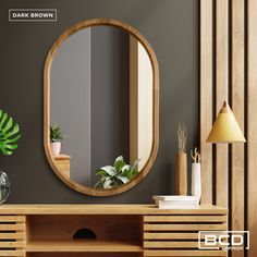 a round mirror on the wall above a wooden table with plants and potted houseplants