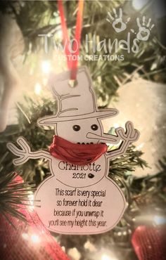 a snowman ornament hanging from a christmas tree