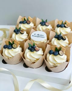 cupcakes with white frosting and blueberries on top