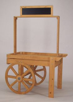 a wooden cart with wheels and a chalkboard on it's back end, against a white background