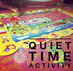 a child's hand is on the floor next to an activity mat that says quiet time