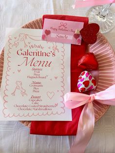 a valentine's menu on a pink plate