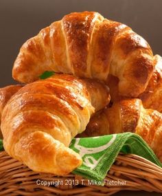 croissants in a wicker basket on a table