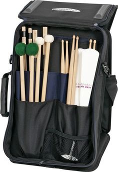 an open black bag with several different items in it, including sticks and toothbrushes