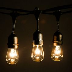 some light bulbs are hanging from a wire with lights on them and one is turned on