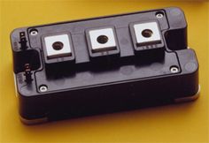 four black and white switches on a yellow surface