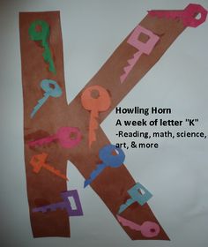 the letter k is made out of paper with scissors and letters cut out on it