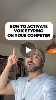 a man in a white t - shirt is pointing to the text how to activate voice typing on your computer