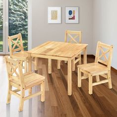 a wooden table and four chairs in a room with hardwood flooring on the side