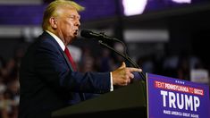 a man in a suit and tie giving a speech