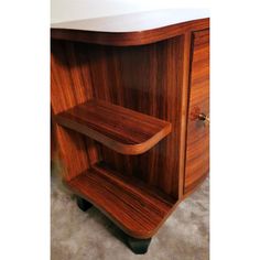 a wooden shelf sitting on top of a carpeted floor