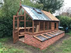 a small wooden building with a glass roof