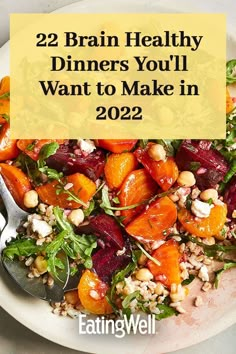 a white plate topped with carrots and spinach next to a fork on top of it