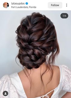 the back of a woman's head with braids in it