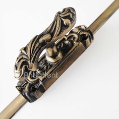 an ornate gold and black handle on a cane