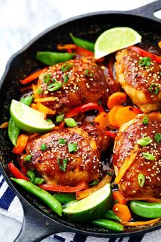 a skillet filled with chicken and veggies