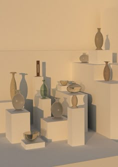 several vases and bowls are arranged on pedestals in an empty room with white walls