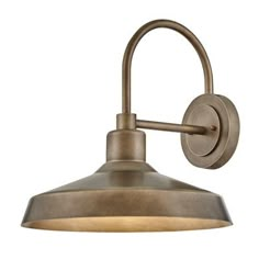 an antique style wall light with a metal shade on the side and a white background