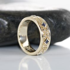 This stunning Celtic wedding ring features princess cut sapphire set gorgeously on the carved Celtic know wedding band. The intricate design makes this ring a perfect choice as a wedding anniversary ring for men and women who are looking for an eye-catching unique wedding ring. Style #R139P-14K-BSAPP • 𝐌𝐞𝐭𝐚𝐥: 𝟏𝟒𝐊 𝐆𝐨𝐥𝐝 • 𝐁𝐚𝐧𝐝 𝐂𝐨𝐥𝐨𝐫𝐬: Rose Gold, Yellow Gold, White Gold Blue Sapphire : *Medium to medium dark blue*Clarity : Natural AAA -Eye Clean*Shape : Princess Cut*Approx. ge Antique Rings Men, Men Sapphire Ring, Wedding Ring Ideas Men, Mens Engraved Rings, Vintage Engagement Rings Men, Sapphire Engagement Ring Men, Men’s Wedding Ring With Sapphire, Unique Mens Engagement Rings, Unique Male Wedding Bands