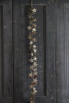 the door is decorated with gold stars and hanging from it's side, as if for christmas or new year's eve