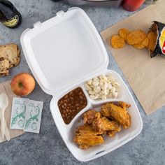 a lunch box with chicken wings, beans and macaroni