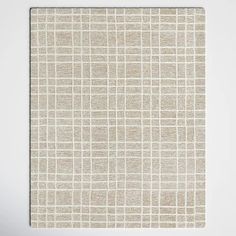 a white and beige wall hanging on the side of a wall with a square pattern