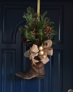 a pair of boots hanging from a door with christmas decorations on the front and side