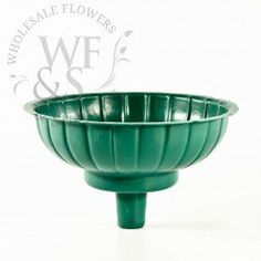 a green bowl sitting on top of a white table