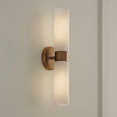 a wall light that is on the side of a wall in a room with white walls