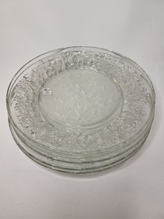 three clear glass plates stacked on top of each other