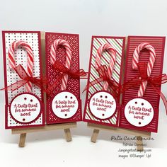 three christmas cards with candy canes on them