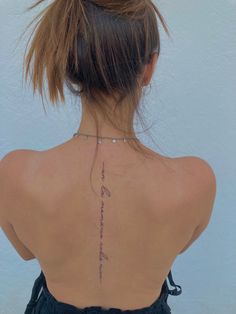 the back of a woman's neck with writing on it