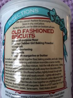 an old fashioned biscuit jar with instructions on the label in front of a purple background