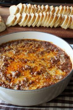 a bowl of chili with bread on the side