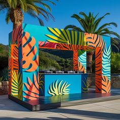 colorfully painted outdoor bar with palm trees and blue sky in the backround