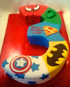 the birthday cake is decorated with superheros and stars