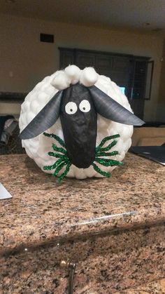 a black and white sheep head on top of a granite counter