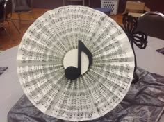 a musical paper fan sitting on top of a table