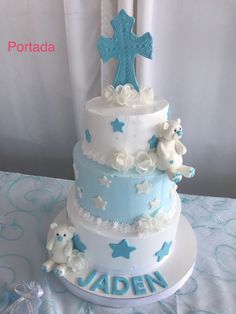 a three tiered cake with blue and white decorations on the top is decorated with teddy bears