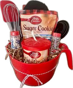 a red bucket filled with baking supplies and cooking utensils